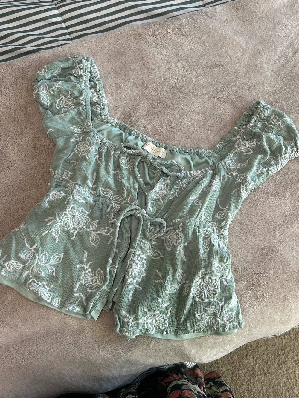 Green floral blouse with white floral embroidery,